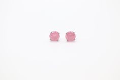 These pink opal stud earrings are perfect for adding a touch of elegance to your daytime look. They are crafted from genuine pink opal, and their unique, natural beauty is sure to turn heads. The earrings are lightweight and comfortable to wear, making them a great choice for everyday wear. Pink Rose Quartz Earrings Gift, Pink Rose Quartz Earrings For Gifts, Classic Pink Sterling Silver Earrings, Pink Rose Quartz Round Earrings, Classic Pink Gemstone Earrings, Pink Birthstone Earrings In Sterling Silver, Pink Sterling Silver Birthstone Earrings, Formal Pink Rose Quartz Jewelry, Sterling Silver Pink Birthstone Earrings