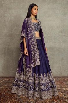 Purple asymmetric cutwork cape with floral embroidered motifs. Paired with floral embroidered scallop hem lehenga and embroidered bustier.
Component: 3
Pattern: Embroidered
Type Of Work: Floral
Neckline: Open
Sleeve Type: Flared Sleeves
Fabric: Raw Silk
Color: Purple
Other Details: 
Scallop hem lehenga
Floral motifs
Asymmetric cape
Occasion: Bride, Sangeet - Aza Fashions Lehenga Floral, Cape Lehenga, Embroidered Bridal Lehenga, Embroidered Bustier, Purple Lehenga, Embroidered Cape, Sangeet Outfit, Jayanti Reddy, Raw Silk Lehenga