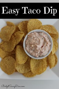 an easy taco dip with tortilla chips on the side and text overlay that reads easy taco dip