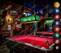 billiards tables and pool balls in a bar with neon signs on the wall