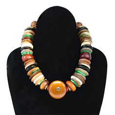 Large amber centerpiece with pearl is surrounded by slices of amber, bone, ebony, green turquoise and brass bead discs. Hangs 17 1/2” African Beads Necklace, African Accessories, Diy Jewelry Display, Making Necklaces, Jewelry Stones, Sports Jewelry, Nice Jewelry, Design Library, Jewelry Artist