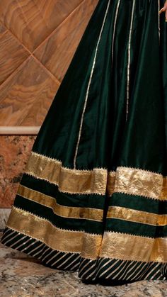 Baisa Dark Green Cotton Silk Lehenga Set for Women - Free Shipping & Easy Returns – Fledgling Wings Festive Green Anarkali Set With Embroidered Border, Festive Green Embroidered Anarkali Set, Designer Wear Green Sharara With Embroidered Border, Designer Green Sharara With Embroidered Border, Green Anarkali Set In Tissue Silk With Traditional Drape, Green Anarkali Set With Traditional Drape In Tissue Silk, Designer Silk Anarkali Set With Embroidered Border, Silk Anarkali Set With Embroidered Border For Designer Wear, Elegant Cotton Silk Anarkali Set With Embroidered Border