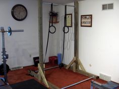 an exercise room with ropes and equipment in the corner, on top of carpeted flooring