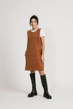 "A cute layering dress, kind of romper-y. It has seams above the bust and at the waist. The skirt has pockets. Wear with the Piper, Blair or last year's Aurora. Tights and boots and done. 97% Cotton / 3% Spandex. Available in Rust Shoulder to hem is 35\" ½\". Model is 5'6\" and wears a size 4. Made in Vancouver, Canada." Casual Fall Pinafore Dress For Workwear, Casual Sleeveless Pinafore Dress For Fall, Fitted Mini Length Pinafore Dress For Fall, Casual Corduroy Winter Dress, Fitted Fall Pinafore Dress With Pockets, Fitted Knee-length Pinafore Dress For Fall, Knee-length Fitted Pinafore Dress For Fall, Fall Knee-length Mini Dress With Pockets, Casual Corduroy Pinafore Dress For Fall