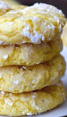 a stack of lemon cookies with powdered sugar on top