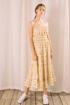 It features a straight elastic gathered neckline with ruffle trim around it and a smocked cinched high waist. It also has adjustable spaghetti straps and a ruffled flowy maxi bottom. Material:Cotton Picnic Gingham Sundress With Ruffles, Spring Gingham Sundress With Ruffles, Daywear Smocked Dress With Ruffle Hem And Straps, Casual Gingham Sundress With Ruffles, Summer Plaid Smocked Dress With Ruffles, Summer Gingham Dress With Tiered Skirt, Gingham Dress With Ruffled Hem And Straps, Daywear Maxi Dress With Spaghetti Straps And Ruffles, Daywear Spaghetti Strap Maxi Dress With Ruffles