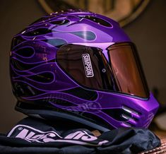 a purple helmet sitting on top of a table