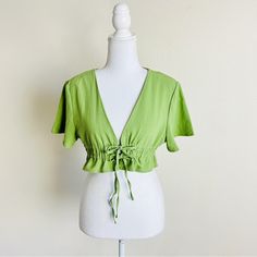 Princess Polly Jamison Reid Green V-Neck Smocked Front Tie Short Sleeve Crop Top Size 6/M Nwot- Took The Tags Inside Off Because It Was Scratchy When I Tried On But It Has Never Been Worn 65% Cotton 35% Polyester 5-11 Summer Rayon V-neck Tops, Summer V-neck Top With Smocked Bodice, Trendy V-neck Top With Smocked Back, Summer V-neck Crop Top For Brunch, Spring Vacation V-neck Crop Top, Bohemian V-neck Top With Smocked Back, Bohemian V-neck Tops With Smocked Back, Summer V-neck Rayon Blouse, V-neck Crop Top For Spring Vacation