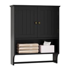 a black cabinet with two doors and some folded towels on the bottom shelf next to it