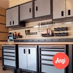 an organized garage with lots of drawers and tools on the counter top in front of it