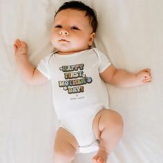 Celebrate her first Mother's Day with a sprinkle of nostalgia. Our retro baby bodysuit is adorned with the heartfelt proclamation 'Happy First Mother's Day' in a vibrant 60s/70s font. This unique gift showcases bright white daisy flowers, making your baby look even cuter if thats even possible. Also, you can add who it's from to make this gift extra 
special! Father's Day Gift Cotton Onesie, White Letter Print Bodysuit As Gift, Mother's Day Cotton Onesie Gift, Playful White Bodysuit Gift, Playful White Bodysuit As Gift, Playful White Bodysuit As A Gift, Cotton Bodysuit With Letter Print As Gift, Funny Mother's Day Onesie With Letter Print, Cotton Letter Print Bodysuit As Gift