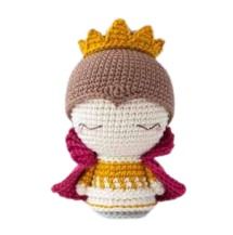 a crocheted doll with a crown on it's head and eyes closed