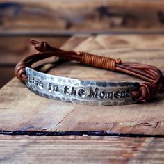 Hand-stamped adjustable bracelet made with: -Your choice of Fine Pewter or Copper -Genuine Leather  Copyright © 2022 DESIGNbyANCE All rights reserved Adjustable Stamped Leather Bohemian Bracelet, Handmade Adjustable Meaningful Bracelets, Adjustable Brown Metal Wrap Bracelet, Casual Adjustable Metal Braided Bracelets, Casual Adjustable Metal Braided Bracelet, Adjustable Stamped Brown Bracelets, Adjustable Engraved Meaningful Bracelets, Adjustable Engraved Meaningful Bracelet, Vintage Adjustable Leather Bracelet For Gift