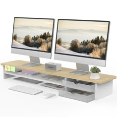 two computer monitors sitting next to each other on top of a wooden desk in front of a white background