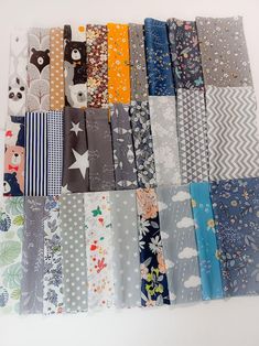 a bunch of different types of fabric on a white table top with the same color and pattern