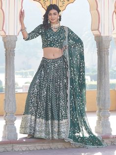 Step into the realm of timeless elegance with this stunning green jacquard lehenga adorned with intricate embroidered work and shimmering sequin detailing. Paired with a matching jacquard choli and a georgette dupatta, all featuring similar embellishments, this ensemble exudes opulence and grace. The lehenga, with its 3.5-meter flair and stitched up to 42 inches with can-can for added volume, offers a flattering silhouette that accentuates your curves beautifully.
The rich green hue of the lehen Transitional Anarkali Green Lehenga, Transitional Green Lehenga With Dupatta, Green Lehenga With Resham Embroidery For Transitional Season, Transitional Green Lehenga With Resham Embroidery, Green Georgette Choli For Transitional Season, Transitional Green Georgette Choli, Transitional Green Traditional Wear For Reception, Designer Green Lehenga For Transitional Season, Green Brocade Sets For Wedding