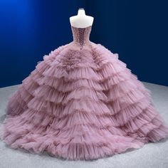 a pink dress is on display in a blue and white room with lights behind it