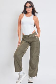 Comfort just got cuter. Meet our Women’s High Rise Nylon Cargo Pants With Bungee Hem - your new closet favorite. This high waisted parachute style pant is constructed with lightweight polyester for a nice airy feel and features decorative grommet detailing to add to the vintage military aesthetic. Fitted with an adjustable bungee tie at the hem so you can alter the look with a straight leg or cinched ankle depending on your mood. Style with a fitted rib tank and boots for an edgy look, or a body Stretch Nylon Wide-leg Parachute Pants, Full-length Khaki Parachute Pants With Cargo Pockets, Full Length Khaki Cargo Parachute Pants, Khaki Full-length Utility Parachute Pants, Stretch Khaki Cargo Parachute Pants, Trendy High Waist Cargo Parachute Pants, High Waist Nylon Pants With Pockets, High Waist Stretch Utility Parachute Pants, Khaki High-waisted Utility Parachute Pants