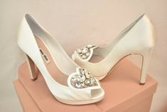 BIANCO/ WHITE SATIN JEWELED CRYSTALS PLATFORM PEEP TOE WEDDING DRESS PUMPS   By MIU MIU PRADA   MADE IN ITALY   100% AUTHENTIC,GUARANTEED!!!   Add some height to your step with a fabulous pair of Satin Dress /Wedding  platforms pumps Miu Miu Prada!   Color: Bianco/white Satin upper Tapered  peep toe Leather Trim Jeweled Crystal Heart Shape Detail  vamp 4 3/4" covered  heel 1/2" front platform Leather lined "MIU MIU" Stamped logo Leather sole Size 37.5-print on the shoes and box   Wear them to ad Satin Dress Wedding, Wedding Platform, Boda Ideas, Wedding Pumps, Wedding Shoes Heels, Pump Dress, Platform Pumps, Crystal Heart, White Satin