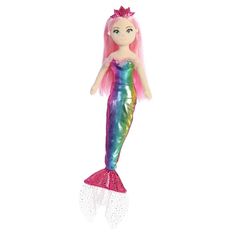 a mermaid doll with pink hair and green tail, standing on a white surface in front of a white background