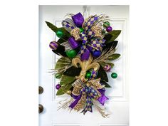 a purple and green wreath on the front door