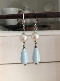 Like all my creations, these earrings were made with care. Very pretty earrings made up of a round mother-of-pearl pearl, a sky blue porcelain drop pearl and small silver pearls. They are light and easy to wear. These pretty earrings will be sent to you quickly in a gift bag. I have lots of pretty jewelry at very affordable prices in my shop: https://rosethalie.etsy.com Do not hesitate to contact me if you would like a particular piece of jewelry or if you have any questions. You can follow me o Affordable Round Bead Pearl Earrings, Silver Beaded Teardrop Earrings As Gift, Silver Beaded Teardrop Earrings For Gift, Elegant Handmade Sterling Silver Beaded Earrings, Elegant Light Blue Beaded Earrings As Gift, Elegant Hypoallergenic Beaded Earrings With Round Beads, Elegant Silver Beaded Hypoallergenic Earrings, Elegant Hypoallergenic Round Beaded Earrings, Light Blue Drop Jewelry For Gift