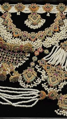 an elaborate necklace with pearls and other beads