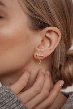 These are 18 karat gold-plated sterling silver stud earrings which have a gently arched metal rod decorated with five tiny round zirconia (which sits on the ear lobe), and a single round zirconia in a four-prong setting hanging underneath it, attached by a delicate golden chain in the shape of a triangle. Golden butterfly clasps secure them to the ear. A unique and glamorous design that will be sure to elevate any look. 🎁 Packaging: Beautifully packed in a box, ready for gifting. 🏷️ This produ Gold Cubic Zirconia Ear Climbers Fine Jewelry, Gold Cubic Zirconia Ear Climbers With Prong Setting, Dainty Gold Plated Ear Climbers, Classic Gold Diamond Ear Climbers, Formal Gold Cubic Zirconia Ear Climbers, Dainty Gold Cubic Zirconia Ear Climbers, Gold Dainty Cubic Zirconia Ear Climbers, Gold Cubic Zirconia Ear Climbers For Formal Occasions, Gold Cubic Zirconia Ear Climbers For Formal Events