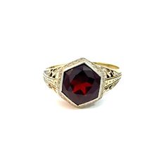 Art Deco garnet doublet ring in 14k white and yellow gold.  This stunning ring features a Greek key pattern down the shoulders and scrolling filigree throughout.   The hexagonal garnet and glass doublet is a rich red hue and surrounded by a white gold bezel. This ring is in very good vintage condition with some abrasion to the garnet doublet.   The Details: Ring size - size 6.75, sizeable Metal type - 14k white and yellow gold (stamped and tested)  Ring weight - 2.8 grams total Gem type - Garnet Glass Doublet Gem dimensions - 9.00 x 9.00 mm Gem cut - Hexagonal Faceted This ring has been inspected by a GIA Graduate Gemologist independent of Treanor House to provide an unbiased opinion of this piece.  To view the shop policies, including returns and shipping, please visit:  https://www.etsy. Formal Garnet Rings Fine Jewelry, Formal Ruby Signet Ring In Fine Jewelry Style, Fine Jewelry Ruby Signet Ring For Formal Occasions, Ruby Signet Ring Fine Jewelry For Formal Events, Ruby Signet Ring For Formal Occasions, Heirloom Garnet Ring For Formal Occasions, Antique Ruby Signet Ring For Formal Occasions, Elegant Ruby Signet Ring With Hallmark, Elegant Garnet Signet Ring For Formal Occasions