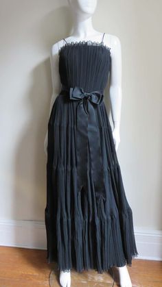 For Sale on 1stDibs - A black silk micro pleated gown from Jean Louis. The fitted bodice has a boned inner corset and spaghetti straps. The long full skirt is comprised of 4 Silk Dresses With Accordion Pleats For Evening, Formal Evening Dress With Accordion Pleats And Fitted Bodice, Evening Dresses With Accordion Pleats And Fitted Bodice, Silk Cocktail Dress With Accordion Pleats, Cocktail Silk Dress With Accordion Pleats, Silk Evening Dress With Pleated Details, Formal Silk Dress With Accordion Pleats, Fitted Accordion Pleats Evening Dress, Silk Evening Dress With Pleated Bodice For Dinner