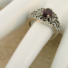 Vintage Estate Natural Garnet Solitaire Filigree Ring. 925 Solid Sterling Silver. The Top Of the Ring Measures 12.5mm, Nearly 1/2 Inch In Length. Set With One 7x5 mm Oval Faceted Natural Garnet Stone. Stamped 925. Excellent Condition/Like New. Classic Ring With Intricate Design For Gift, Classic Engraved Filigree Ring, Sterling Silver Filigree Ring For Formal Occasions, Elegant Filigree Ring With Birthstone, Ornate Filigree Ring For Promise, Elegant Filigree Ring With Birthstone For Wedding, Ornate Filigree Promise Ring, Classic Engraved Filigree Ring As Gift, Classic Engraved Filigree Ring Gift