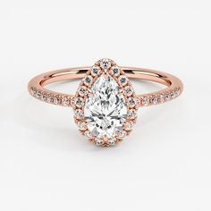 a rose gold engagement ring with an oval cut diamond and pave diamonds on the band