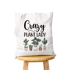 a white tote bag that says crazy plant lady on it with potted plants