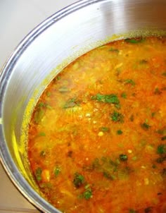 a pot filled with soup sitting on top of a stove