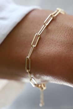 24kt gold plate elongated link chain bracelet. Smooth and textured links. -Color: Gold -Measures adjustable 6"-7 3/4" -Made in the USA Quirky Bracelets, Link Chain Bracelet, Gold Overlay, Popular Jewelry, 24kt Gold, Gold Bracelet Chain, Bracelet Stack, Paper Clip, Jewelry Trends