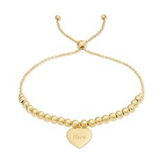 This Engravable Heart Tag Beaded Gold Bolo Bracelet is a classic accessory that adds just a bit of interest to your look.  Both petite and lightweight  this gold plated sterling silver 9" adjustable bolo bracelet can be worn alone or stacked with other bracelets.  Accented with a 1/2" engravable heart tag  perfect for adding a name  initial or monogram. Classic Adjustable Jewelry With Heart Charm, Classic Adjustable Heart Charm Jewelry, Adjustable Yellow Gold Bracelet For Mother's Day, Personalized Gold Jewelry With Heart Beads, Gold Heart-shaped Jewelry With Adjustable Length, Adjustable Length Heart-shaped Gold Jewelry, Classic Adjustable Yellow Gold Charm Bracelet, Classic Adjustable Bracelet With Heart Charm, Classic Adjustable Bracelets With Heart Charm