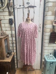 Vintage Laura Ashley pink white patterned tunic dress size M UK 12. 100% Cotton. Original 1970's label "Laura Ashley, Made in Wales". Made at the factory in Carno, mid Wales. No size on label but fits me and I am UK 10/12 - please check measurements to be sure it will fit you. Short sleeves, pleat detail at front and back, has been cut down to make a shorter dress - would originally have been longer. Size:  Chest: 36 inches; Length: 39.5 inches. Weight: allow up to 1 kg once packed. Good vintage Pink Printed Dresses For Daywear, Pink Printed Daywear Dresses, Pink Printed Midi Dress For Daywear, Pink Tunic Dress For Daywear, Vintage Pink Printed Dresses, Pink Printed Tunic Dress, Spring Pink Printed Tunic, Laura Ashley 1970s, Laura Ashley Vintage Dress