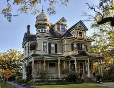 an old victorian style house with a turret on the top floor and two dormies