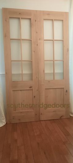 two wooden doors sitting on top of a hard wood floor