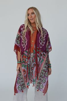 You'll add a stunning addition to your boho wardrobe with our Tabitha Floral Kimono, sure to become a cherished piece in your collection, adding a touch of bohemian glamour to every occasion! You'll love layering with this eye-catching kimono becasue it features: Lightweight, woven, slightly sheer fabric with a so pretty print throughout Relaxed and loose kimono silhouette Classic open front closure Loose kimono style sleeves and side slits created by single side seams So cute tassel details alo Bohemian Kimono With Boho Print For Beach Cover-up, Red One-size Kimono For Festivals, Festive Bohemian Kaftan With Floral Print, Multicolor Boho Print Hippie Kimono, Bohemian Printed Kimono For Beach Cover-up, Hippie Multicolor Boho Print Kimono, Bohemian Festive Kaftan, Multicolor Free Size Boho Print Kimono, Multicolor Boho Print Free Size Kimono