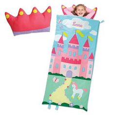 a child's sleeping bag with a princess castle on it and a pink pillow