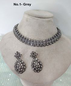 * Light weight Silver necklace Set with earrings Tikka as shown in the     pic.  * Studded with crystals and rhinestones.  * One of a Kind. *Adjustable at any neck. *No.1 to No.4 *Necklace width- 0.6 inches *Earrings length- 1.7 inches Silver Jewelry Sets With Stone Work For Celebration, Bollywood Style Silver Necklace With Matching Earrings, Hand Set Round Jewelry Sets For Parties, Elegant Heavy Metal Jewelry Sets, Heavy Metal Necklaces For Parties, Silver Bollywood Jewelry Sets For Weddings, Bollywood Style Silver Jewelry Sets For Weddings, Elegant Round Kundan Necklace, Silver Bridal Necklace With Hand-set Metal