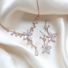 Dainty and elegant Rose gold Bridal jewelry set. Created in a lovely vine floral design that sparkles with Cubic zirconia stones - Necklace measures 16 inches and extends to 18 inches- Earrings dangle 1-3/8"- Rose gold finish- Premium cubic zirconia stones - Nickel free- Available in rose gold, yellow gold and rhodium finish. PLEASE ALLOW APPROX 10 BUSINESS DAYS FOR COMPLETION BEFORE SHIPPING. FOR MATCHING PIECES SIMPLY TYPE "LILY" IN THE SEARCH BAR Elegant Jewelry Gold, Simple Rose Gold Jewelry, Rose Gold Jewellery Aesthetic, Floral Necklace Jewelry, Rose Gold Bridal Jewelry Set, Rose Gold Jewelry Set, Stylish Jewelry Accessories, Wedding Jewelry Gold, Rose Gold Necklaces