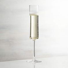 a glass filled with liquid sitting on top of a table