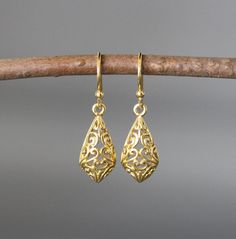 "24k matte gold vermeil filigree charms dangle from 18k gold vermeil balled earwires. Wear these elegant earrings everyday as they complete any outfit. Gold filigree charms: 9x19mm Total length of earrings: 1 1/8\" All gold is gold vermeil. This earrings are available in bright silver... www.etsy.com/listing/630528036/silver-filigree-earrings These earrings are also available in oxidized silver... www.etsy.com/listing/688867970/silver-filigree-earrings As the owner, maker, designer, and curator Luxury Gold-plated Gold Danglers, Luxury Gold Danglers With Elegant Design, Luxury Elegant Gold-plated Danglers, Luxury Gold Danglers In Sterling Silver, Luxury Traditional Yellow Gold Danglers, Gold Teardrop Earrings With Intricate Design, Gold Teardrop Earrings With Intricate Design As Gift, Delicate Gold Filigree Earrings, Gold Teardrop Earrings With Lever Back As Gift