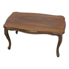 a wooden coffee table with curved legs and an oval shaped top, on a white background