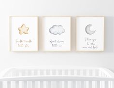 three nursery prints on the wall above a crib