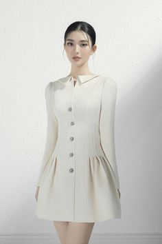 Designer Long Sleeve Winter Dresses, Designer Long Sleeve Mini Dress, Luxury Winter Mini Dress, Luxury Fitted Mini Dress For Winter, Luxury Long Sleeve Mini Dress For Office, Designer Long Sleeve Fitted Mini Dress, Elegant Cream Mini Dress For Winter, Luxury White Dress With Buttons, Designer Fitted Winter Dress