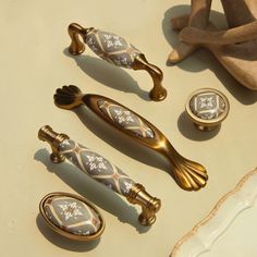 decorative handles and knobs are displayed on a table