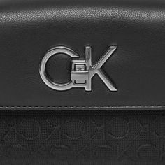 Brand: Calvin Klein Gender: Women Type: Bags Season: Spring/Summer PRODUCT DETAIL • Color: black • Pattern: plain • Fastening: with clip • Size (cm): 12x18x4 • Details: -handbag -with shoulder strap COMPOSITION AND MATERIAL • Composition: -78% polyester -22% polyurethane Black Top Handle Shoulder Bag With Logo, Black Top Handle Bag With Logo Hardware, Classic Black Shoulder Bag With Logo, Classic Travel Satchel With Logo Hardware, Formal Black Shoulder Bag With Logo Hardware, Modern Satchel With Logo Hardware For Daily Use, Black Satchel Bag With Logo Hardware, Black Bags With Logo Hardware For Daily Use, Daily Use Black Bags With Logo Hardware